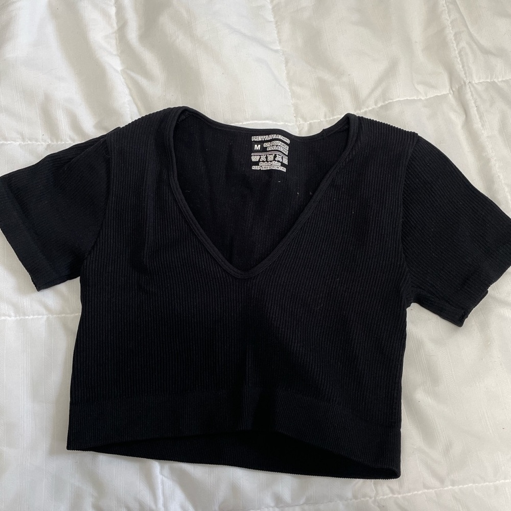 Pretty Little Thing Black Top. Size medium, but fits like a small. Brand new.